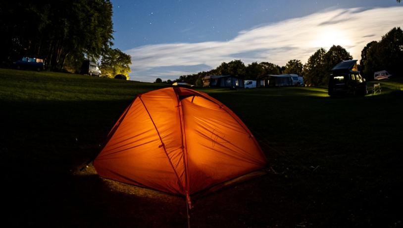 A tent pitched at Camp Møns Klint on a starry night.