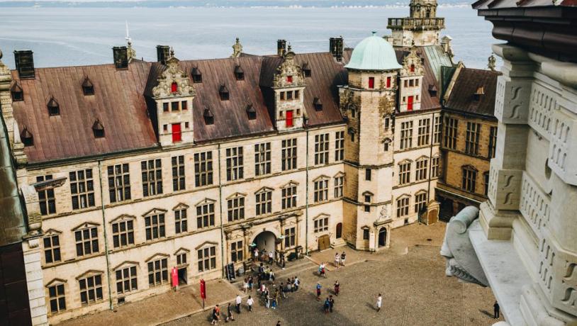 A view of the courtyard at Kronborg Castle in Helsingør, Denmark, including a view of the sea beyond it