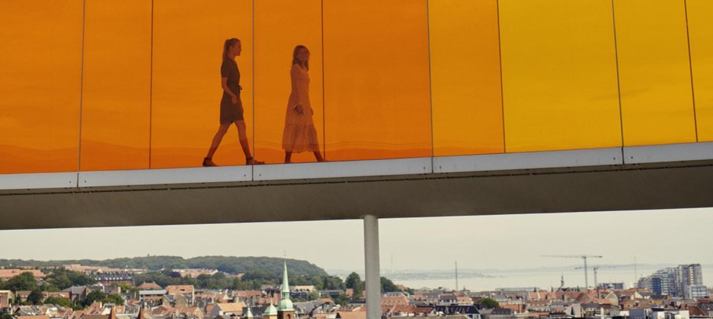 Two people walking in Your rainbow panorama, ARoS Aarhus Art Museum