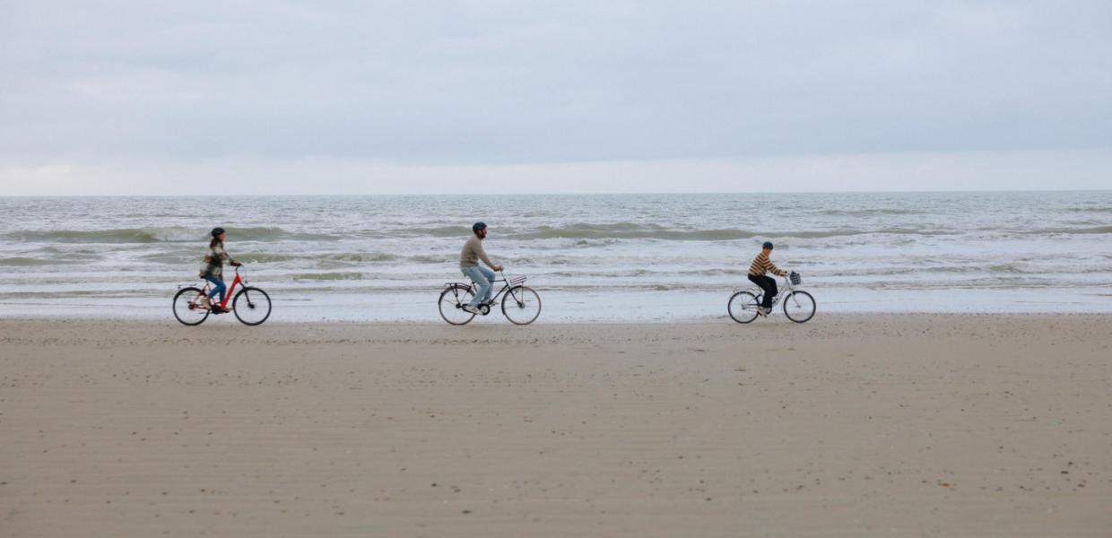 Family cycling on the beach of the Danish North Sea coast