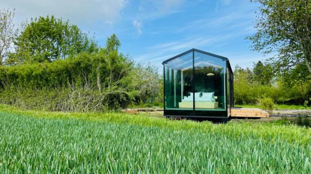 Lolland Glass House in a field