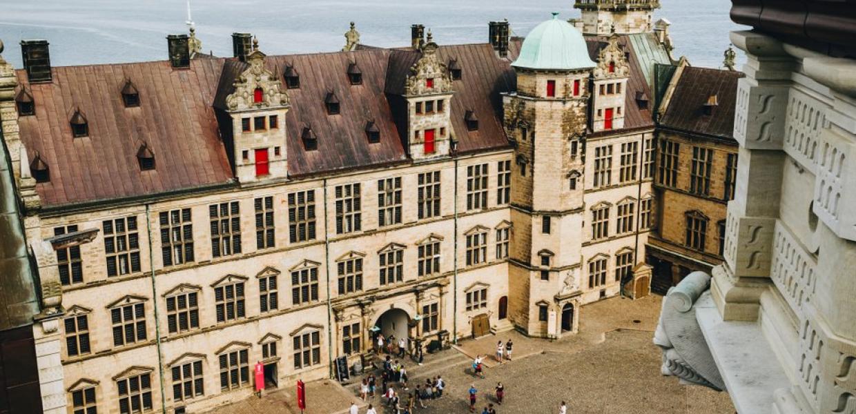 A view of the courtyard at Kronborg Castle in Helsingør, Denmark, including a view of the sea beyond it