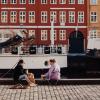 Two women sitting at Nyhavn in Copenhagen
