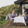 A family sitting outside in a summer house in Hirtshals