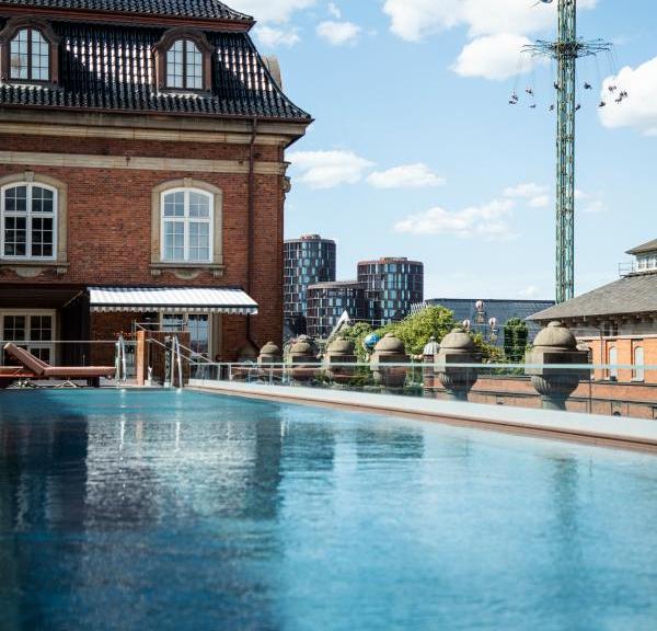 The outdoor pool at Villa Copenhagen with Tivoli Gardens in the background
