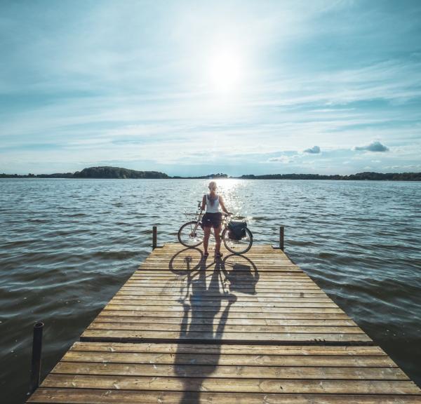 Cyclist standing at Soendersoe lake in Maribo, Lolland-Falster