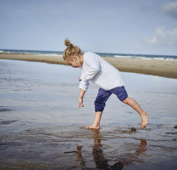 Child at Saltum Strand beach, North Jutland in Denmark