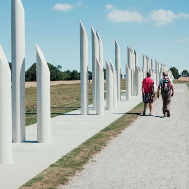 Couple walking along Jellinge monuments in Jutland 