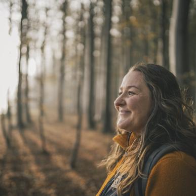 Woman hiking in a forest in Denmark