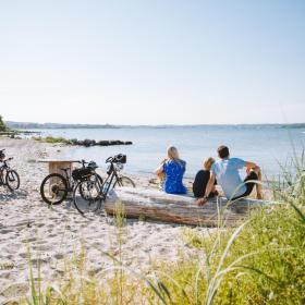 Family at a beach with their bikes in Southjutland