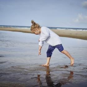 Child at Saltum Strand beach, North Jutland in Denmark