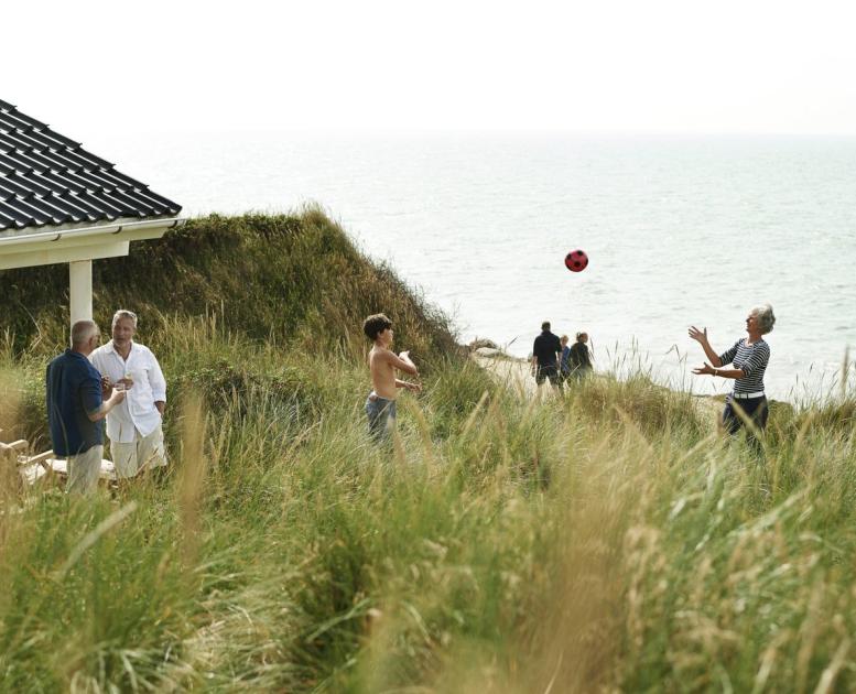 Family playing in summer house near beach, West Jutland