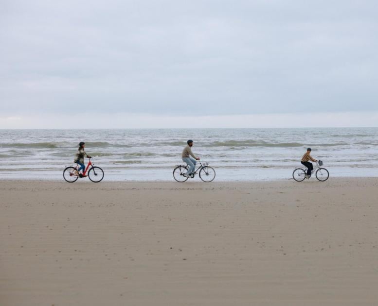 Family cycling on the beach of the Danish North Sea coast